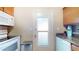 Functional kitchen featuring a door, wooden cabinets, and modern appliances at 1140 S Orlando Ave # F-3, Maitland, FL 32751