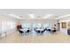 Well lit recreation room with tables, chairs, and serene lake view at 1140 S Orlando Ave # F-3, Maitland, FL 32751