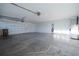 Spacious, well-lit garage featuring plentiful storage and a secure entry door at 11507 Lake Dr, Leesburg, FL 34788