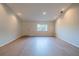 Unfurnished living room with hardwood floors, fresh paint, and natural light at 11507 Lake Dr, Leesburg, FL 34788