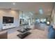 Staged living room with hardwood floors that opens to the kitchen, complemented by modern decor at 11507 Lake Dr, Leesburg, FL 34788