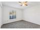 Bedroom featuring neutral carpet, ceiling fan, and a well-lit window at 1239 Woodman Way, Orlando, FL 32818