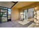 View of the covered patio featuring concrete flooring and a sliding glass door leading to the interior at 1239 Woodman Way, Orlando, FL 32818