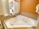 Bright bathroom featuring a luxurious jetted tub for a relaxing spa-like experience at 12544 Floridays Resort Dr # 102, Orlando, FL 32821