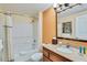 Well-lit bathroom with granite countertops, a decorative mirror, and a shower-tub combination at 12544 Floridays Resort Dr # 102, Orlando, FL 32821