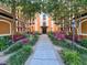 Beautifully landscaped courtyard view with benches and colorful plants at 12544 Floridays Resort Dr # 102, Orlando, FL 32821