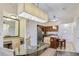 Open dining area with glass table and chairs, integrated with kitchen, creating a modern and social space at 12544 Floridays Resort Dr # 102, Orlando, FL 32821