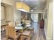 Inviting dining area with modern light fixture, sleek table, and bench seating, perfect for gatherings at 12544 Floridays Resort Dr # 102, Orlando, FL 32821