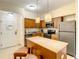 Well-equipped kitchen with stainless steel appliances and a breakfast bar at 12544 Floridays Resort Dr # 102, Orlando, FL 32821
