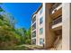 View of the tan building exterior featuring multiple stories with screened balconies and stairs leading to the upper levels at 1301 Tuscan Ter # 9405, Davenport, FL 33896