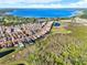 Community aerial view showcases homes near a stunning blue lake and natural green space at 13628 Abberwick Dr, Orlando, FL 32832