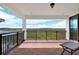 A covered balcony with brick floor has black metal railing and offers expansive green views at 13628 Abberwick Dr, Orlando, FL 32832