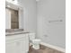 Bathroom featuring granite countertop, vanity, toilet, and tile floor at 13628 Abberwick Dr, Orlando, FL 32832