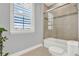 Bright bathroom features a tiled shower with glass door and window with shutters for natural light at 13628 Abberwick Dr, Orlando, FL 32832