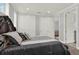 Bedroom featuring a large bed, gray tones, and dual closets at 13628 Abberwick Dr, Orlando, FL 32832