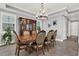 Formal dining room featuring a large wooden table with ornate chairs and a chandelier at 13628 Abberwick Dr, Orlando, FL 32832