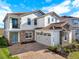 Stunning two-story home boasting a tile roof, stone accents, a spacious two-car garage and a brick-paved driveway at 13628 Abberwick Dr, Orlando, FL 32832