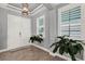 Elegant foyer features tile flooring, ample natural light from shuttered windows, and a modern light fixture at 13628 Abberwick Dr, Orlando, FL 32832