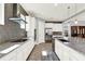 Modern kitchen with stainless steel appliances, white cabinetry, and granite countertops at 13628 Abberwick Dr, Orlando, FL 32832