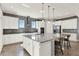 Bright kitchen featuring a large island with granite countertops and stainless steel appliances at 13628 Abberwick Dr, Orlando, FL 32832