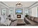 Cozy living room featuring a fireplace, large windows, and comfortable seating at 13628 Abberwick Dr, Orlando, FL 32832