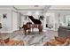 Grand living room featuring a baby grand piano and warm, inviting decor at 13628 Abberwick Dr, Orlando, FL 32832