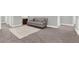 Cozy living room showcases plush carpet, a comfortable sofa, and neutral tones, creating a relaxing atmosphere at 13628 Abberwick Dr, Orlando, FL 32832
