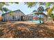 Well-maintained backyard with mature trees and a screened-in pool area, perfect for enjoying the outdoors at 1404 Barcelona Ct, Winter Springs, FL 32708