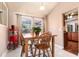 Bright dining area with a wooden table, chairs, and natural light pouring in from the windows at 1404 Barcelona Ct, Winter Springs, FL 32708
