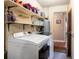 Functional laundry room featuring modern appliances and ample shelving for organized storage solutions at 1404 Barcelona Ct, Winter Springs, FL 32708