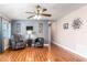 The living room has wood flooring, leather chairs and a ceiling fan at 1404 Barcelona Ct, Winter Springs, FL 32708