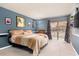 Serene main bedroom with blue walls, plush carpet, and a cozy atmosphere at 1404 Barcelona Ct, Winter Springs, FL 32708