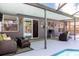 Covered outdoor patio overlooking the pool and landscaped backyard at 1404 Barcelona Ct, Winter Springs, FL 32708