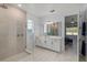 Bathroom featuring tiled glass shower, double sink vanity, and access to bedroom at 14399 Wabasso Loop, Winter Garden, FL 34787