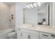Bathroom with white vanity, bathtub, toilet, and tiled walls at 14399 Wabasso Loop, Winter Garden, FL 34787