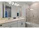 Bathroom featuring double sinks, walk-in shower with glass door at 14399 Wabasso Loop, Winter Garden, FL 34787