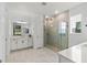 Bright bathroom featuring a glass shower enclosure, modern fixtures, and neutral color palette at 14399 Wabasso Loop, Winter Garden, FL 34787