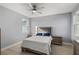 Bright bedroom with large window, ceiling fan, and plush bed and matching nightstands at 14399 Wabasso Loop, Winter Garden, FL 34787