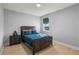 Cozy bedroom features a comfortable bed with blue bedding and a matching nightstand, offering a relaxing retreat at 14399 Wabasso Loop, Winter Garden, FL 34787