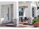 Covered front porch featuring brick columns and patio seating with manicured garden beds at 14399 Wabasso Loop, Winter Garden, FL 34787