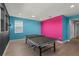 Bright game room with colorful walls, a ping pong table, and an open doorway to another part of the house at 14399 Wabasso Loop, Winter Garden, FL 34787