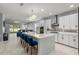 Bright kitchen featuring a large center island with seating and stainless steel appliances at 14399 Wabasso Loop, Winter Garden, FL 34787