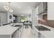 Open concept kitchen with stainless appliances, center island, and view of the living and dining areas at 14399 Wabasso Loop, Winter Garden, FL 34787