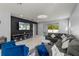 Modern living room features an accent wall, stylish furnishings, and sliding glass doors to the backyard at 14399 Wabasso Loop, Winter Garden, FL 34787