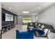 Modern living room with accent wall, tile floors, recessed lighting and sectional sofa at 14399 Wabasso Loop, Winter Garden, FL 34787