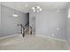 Open-concept room with high ceiling, tile floors, and decorative staircase at 14399 Wabasso Loop, Winter Garden, FL 34787