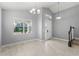 Light-filled living room with high ceilings, tile floors and modern light fixtures at 14399 Wabasso Loop, Winter Garden, FL 34787