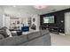 Open-concept living room with decorative lighting and television on accent wall at 14399 Wabasso Loop, Winter Garden, FL 34787
