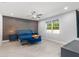 Spacious main bedroom featuring an accent wall, modern furnishings, and a large window at 14399 Wabasso Loop, Winter Garden, FL 34787