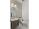 Chic powder room featuring patterned wallpaper, elegant lighting, and a modern vanity at 14399 Wabasso Loop, Winter Garden, FL 34787